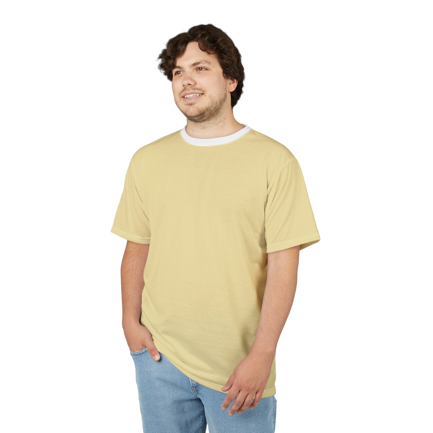 Man wearing a light yellow t-shirt and blue jeans on a white background