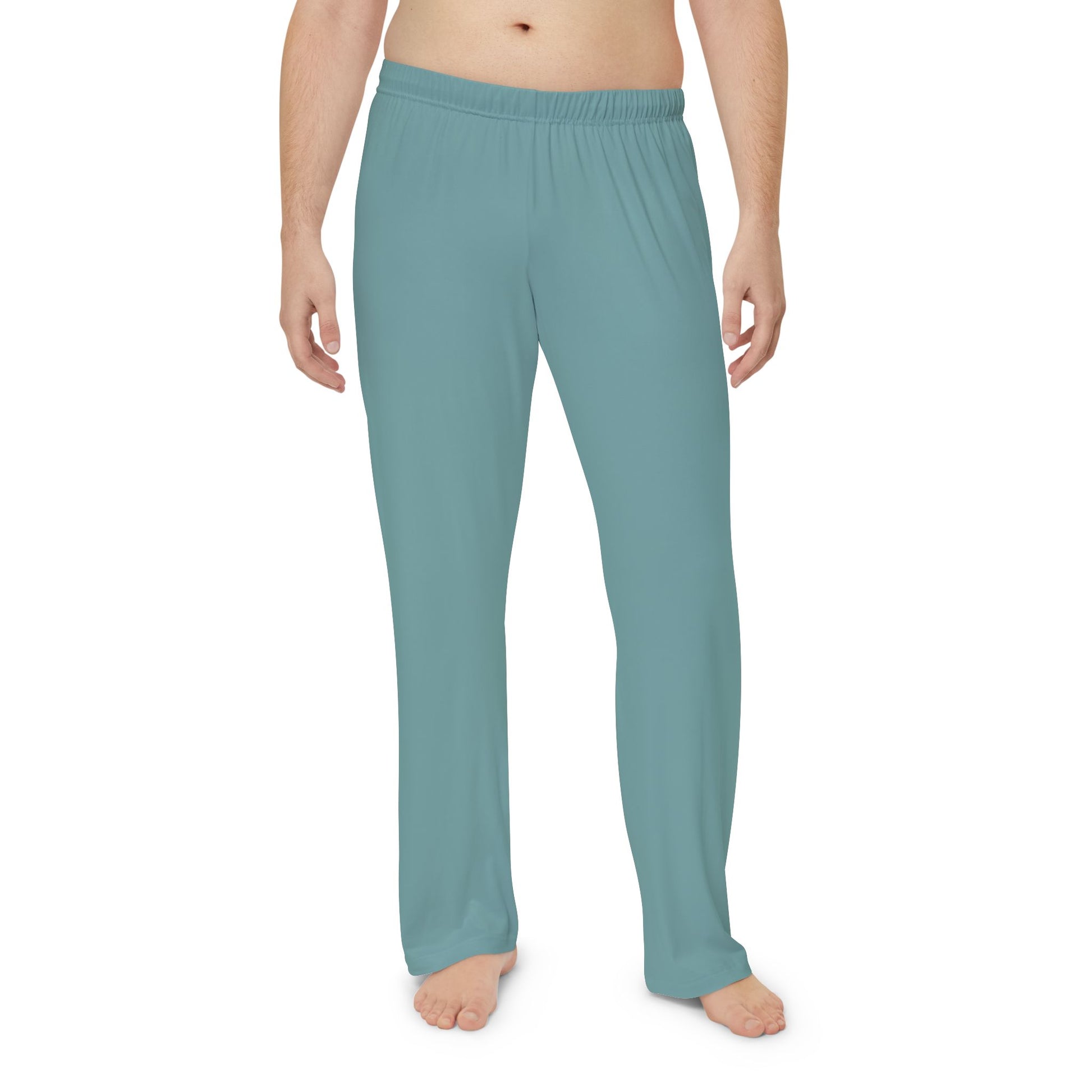 Teal pajama pants worn by a person on a white background