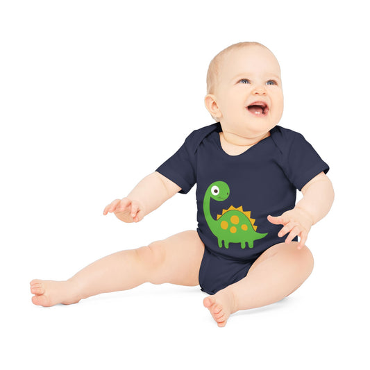 Baby wearing a navy blue onesie with a green dinosaur design on a white background.