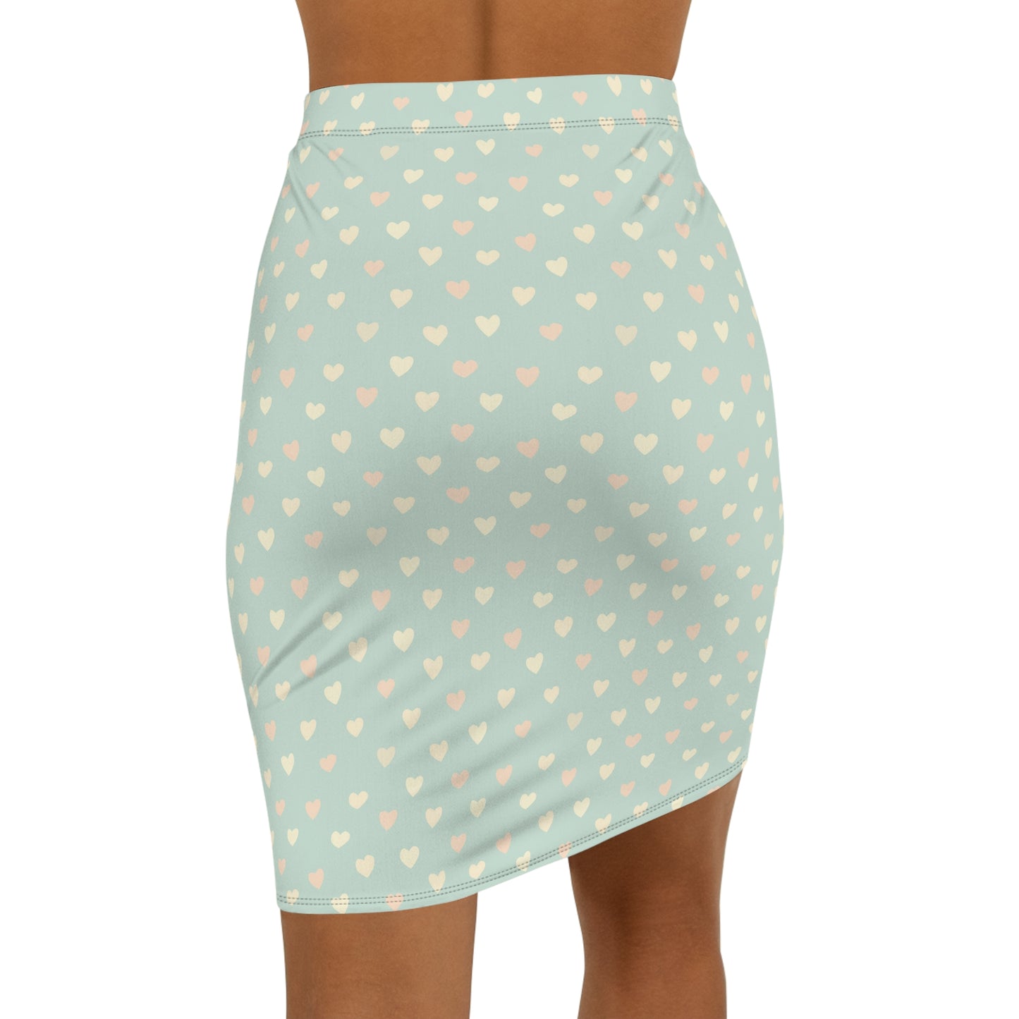 Light blue skirt with heart pattern worn by a person on a white background